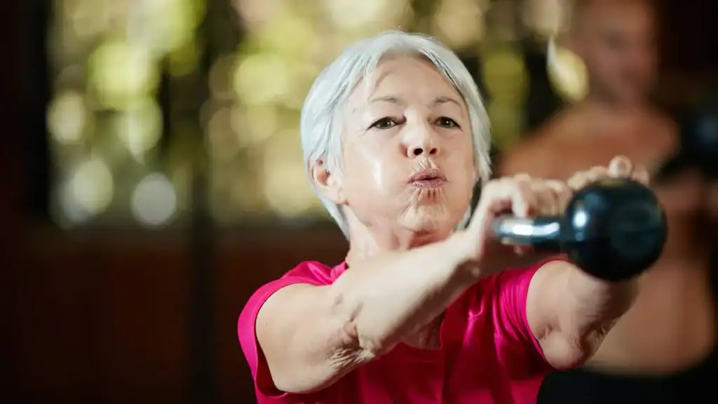Toning Arms After 60: Empowering Womens Fitness Through Effective Weight Training 1 Older woman doing weight training Wickford to help her strength and longevity